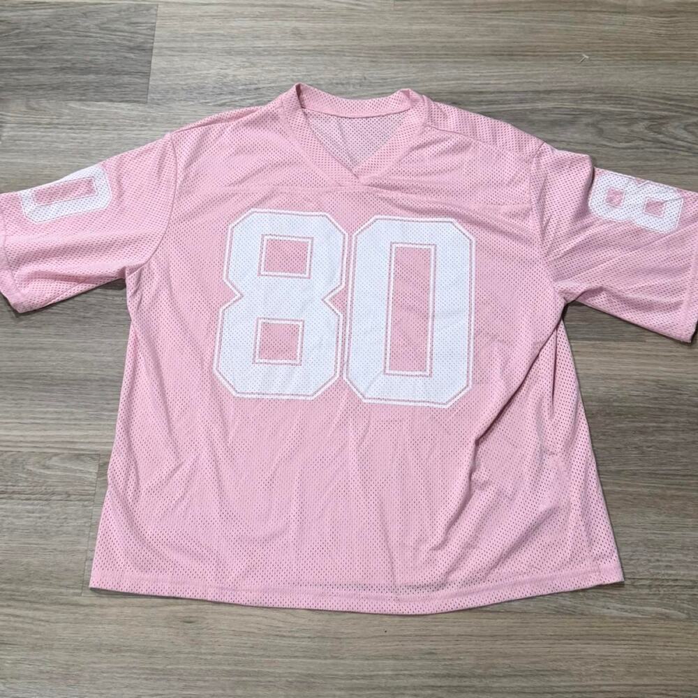 Pink mesh football style jersey featuring